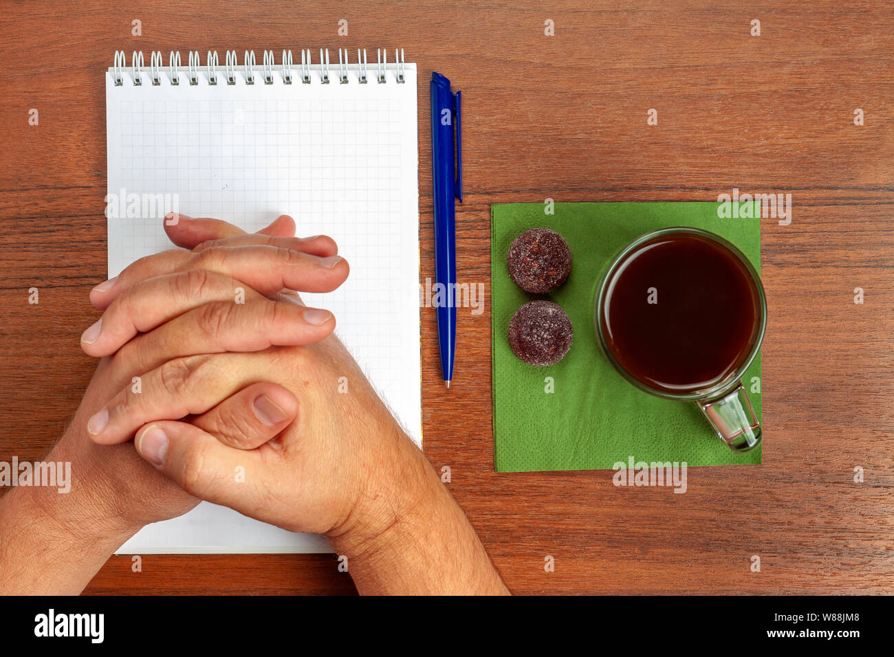 On the table lie a pen, notebook, tea, sweets during negotiations Stock Photo