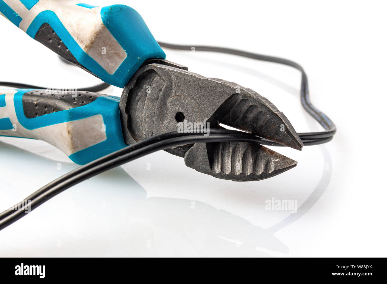 Old pliers cut the wire on a light background Stock Photo