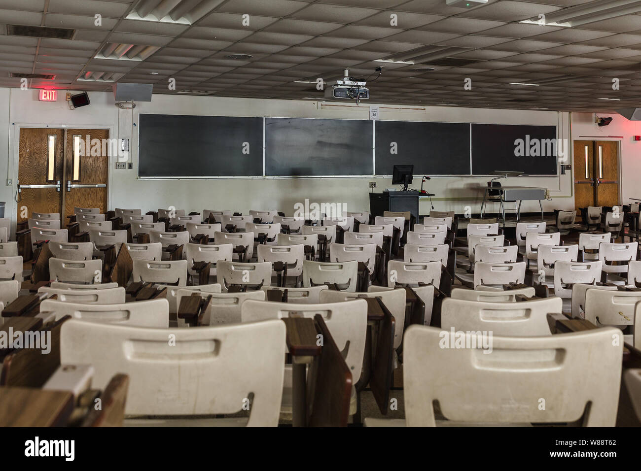 University college large classroom desk, chairs, chalk board, empty Stock Photo