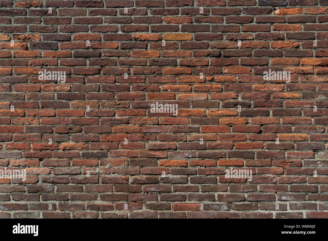 Real vintage Bumpy, rough and old brick texture with imperfect, dilapidate, impair and defective running bond pattern. Stock Photo