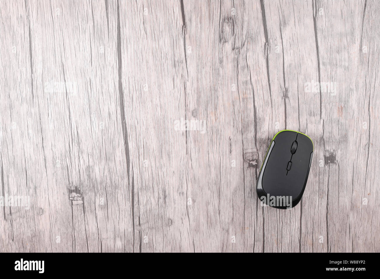 Wireless computer mouse on wooden background Stock Photo