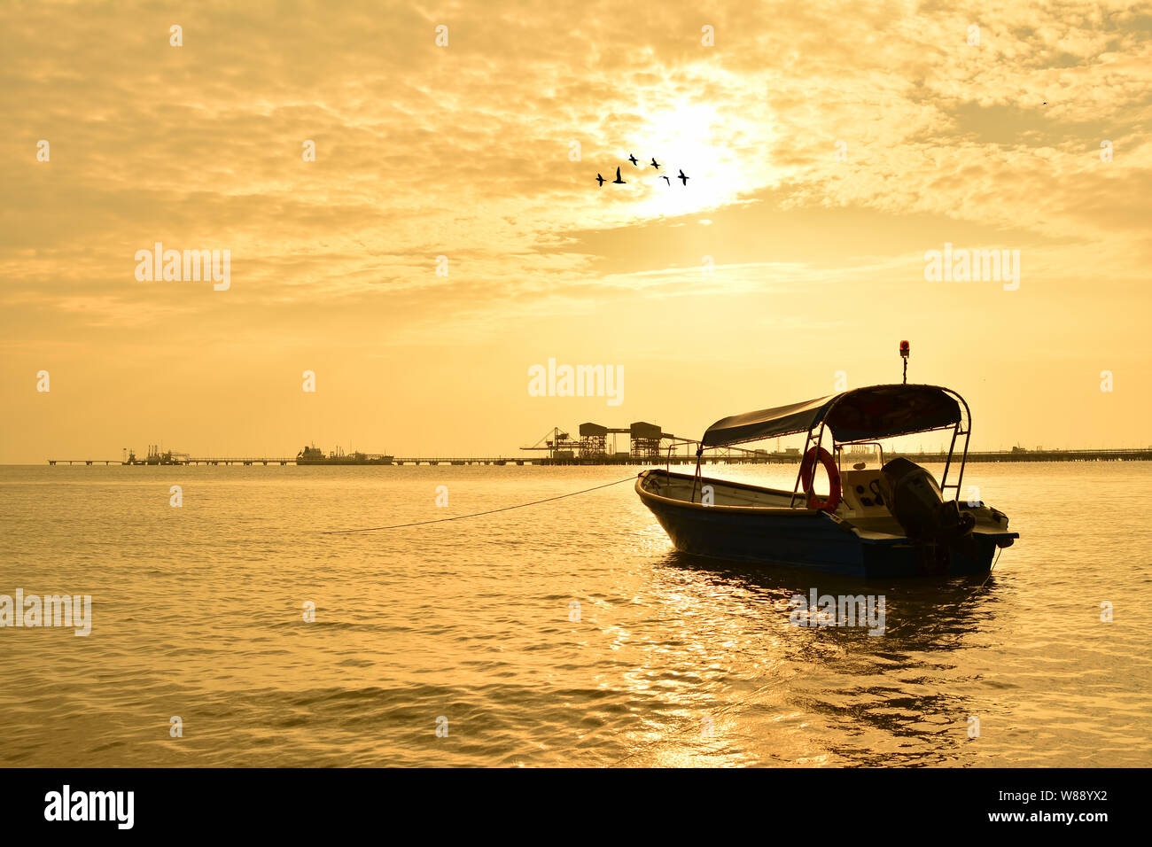 Fisherman boat with sunset background Stock Photo - Alamy
