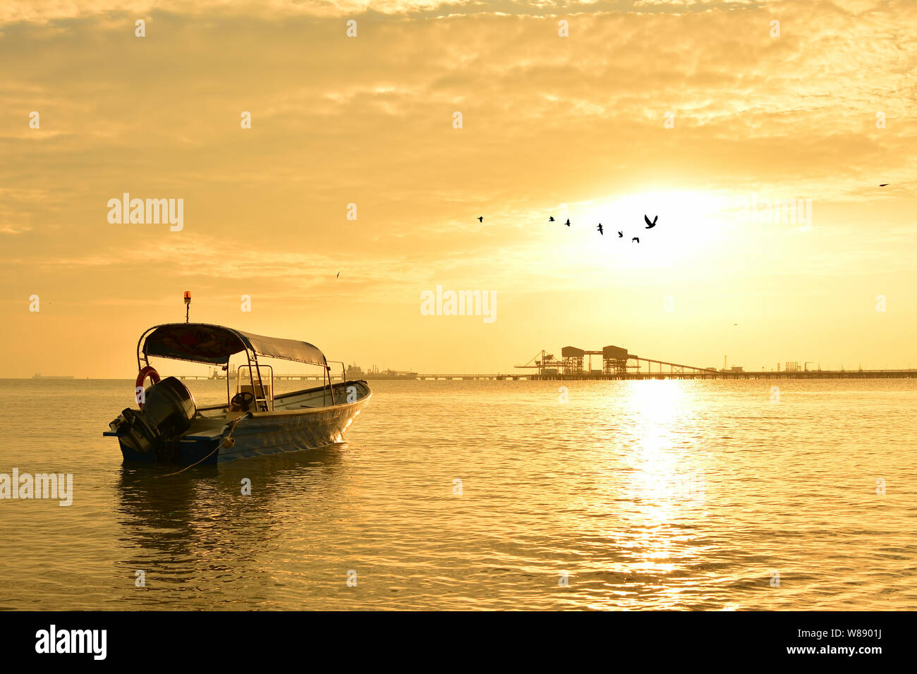 Fisherman boat with sunset background Stock Photo - Alamy