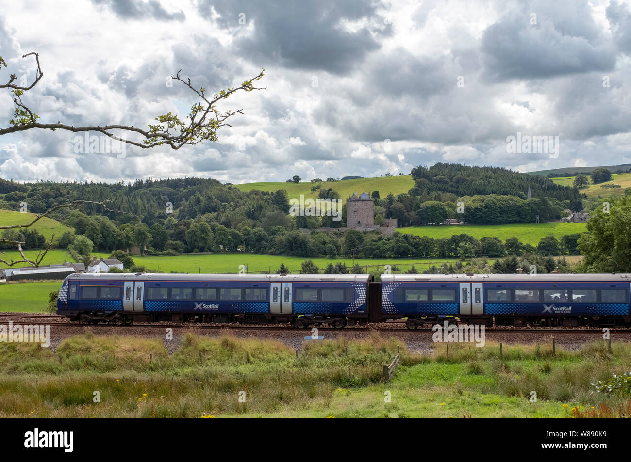 A Scotrail train passes Borthwick Castle, Midlothian on its journey on