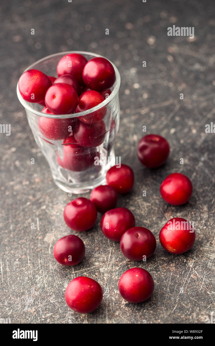 The red cherry plums fruit in glass. Stock Photo