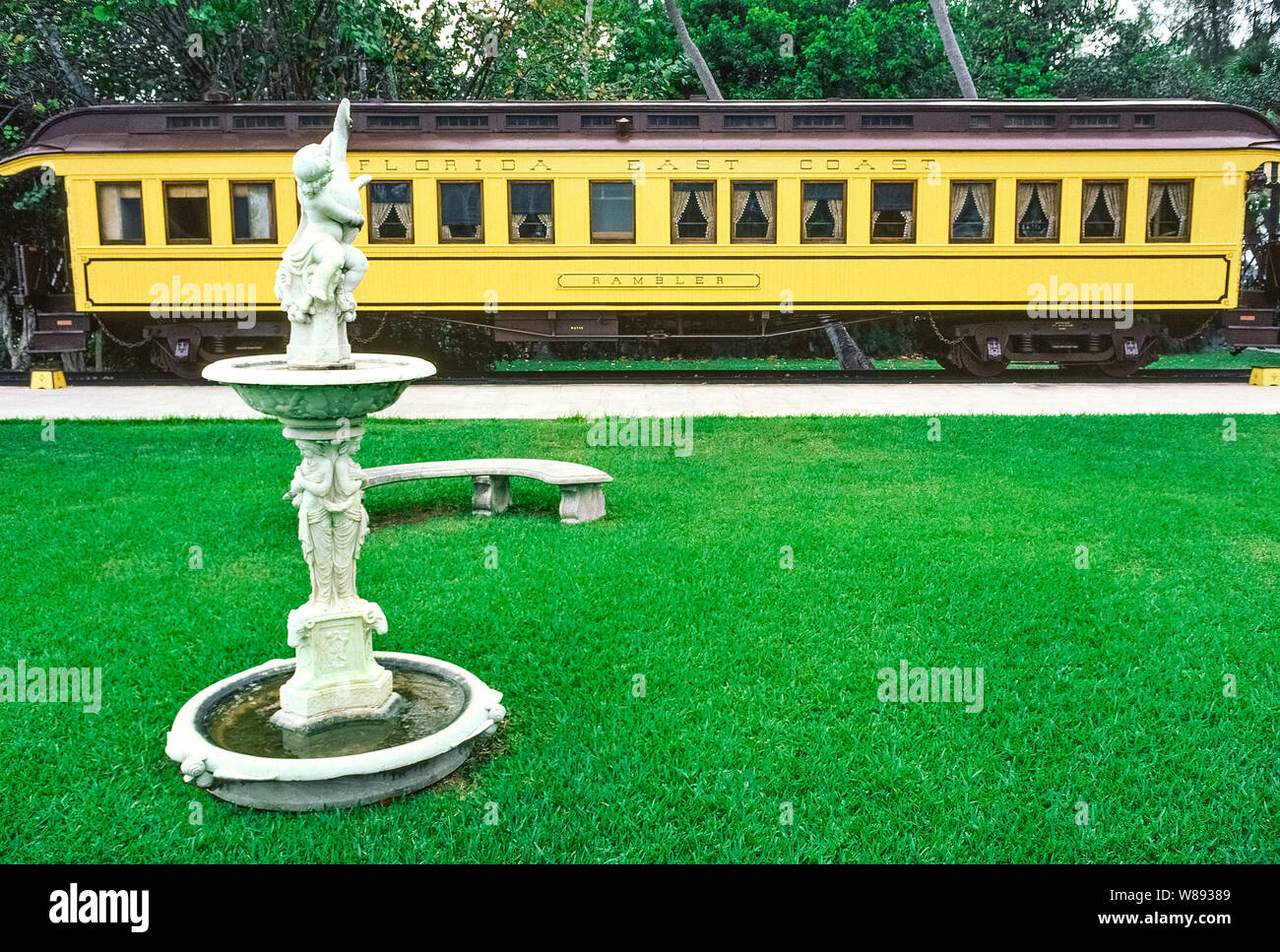 The private 1886 railcar used for business by the owner of the Florida East Coast Railway, Henry M. Flagler, sits outside his opulent mansion, Whitehall, that is now the Flagler Museum in Palm Beach, Florida, USA. Called 'a palace on wheels,' the Victorian-styled train car features a wood-paneled office, kitchen, Flagler's private stateroom with bath, and sleeping berths for visitors. Officially named Railcar No. 91, the 'Rambler' was repainted dark green and moved under cover of a new pavilion at the museum in 2004. Stock Photo
