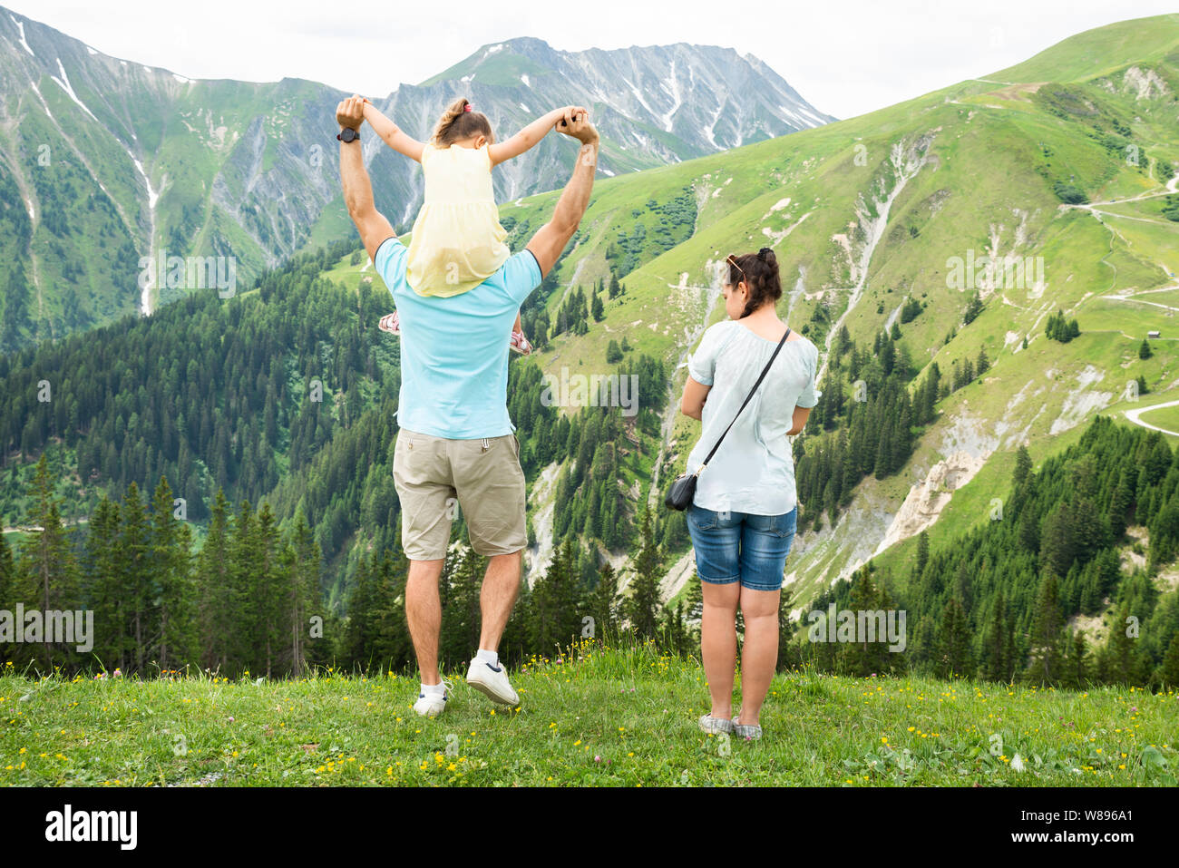 Rear View Of Family Looking At Panoramic Mountain View Stock Photo - Alamy