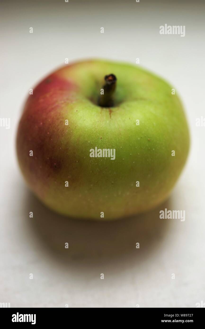 small green red apple on the white table Stock Photo