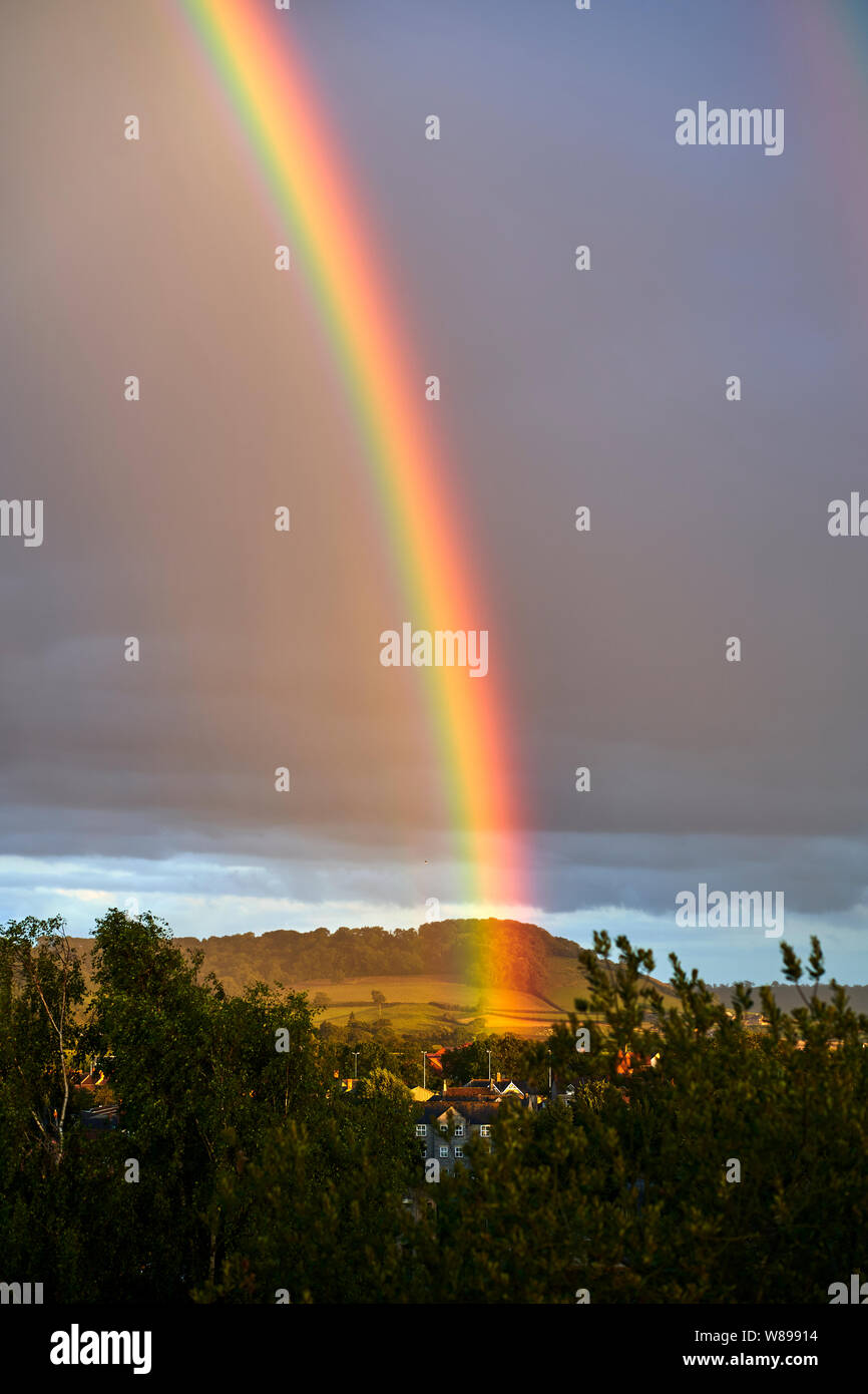 Portrait view of a sunset and a rainbow in the City of Wells, Somerset, UK Stock Photo