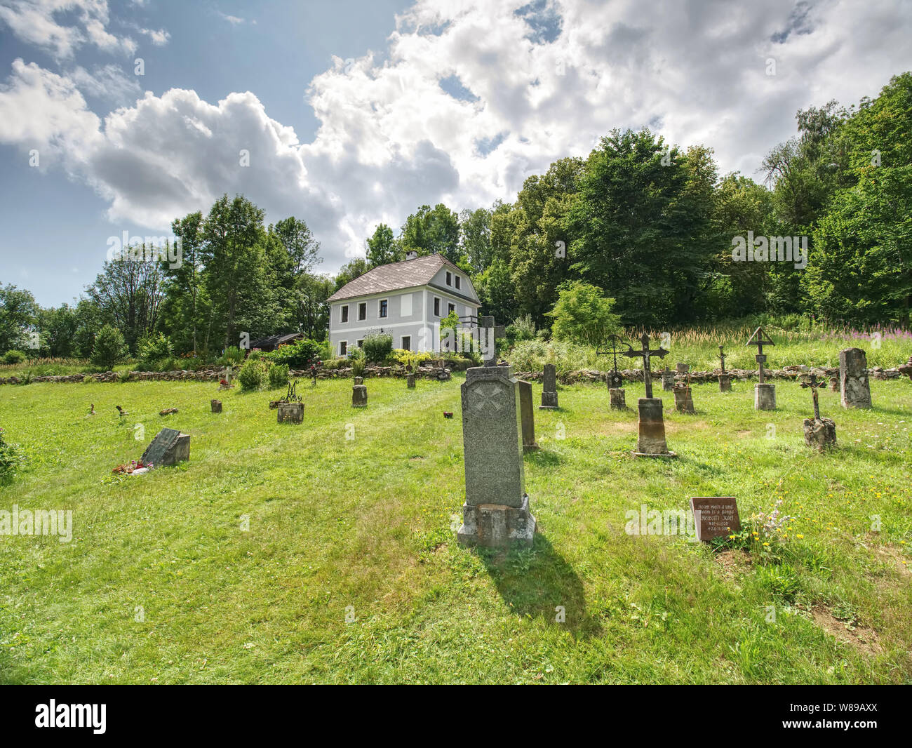 Church of st. John of Nepomuk and Graveyard, Zadni Zvonkova, Czech Republic. 15th of July 2019.  Neo-Gothic building in an abandoned border village wi Stock Photo