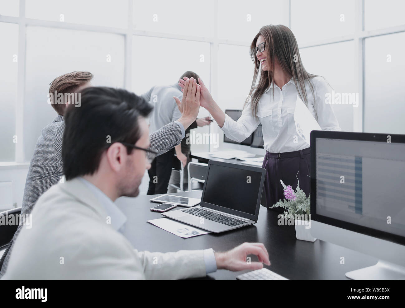 employees giving high five to the workplace Stock Photo - Alamy