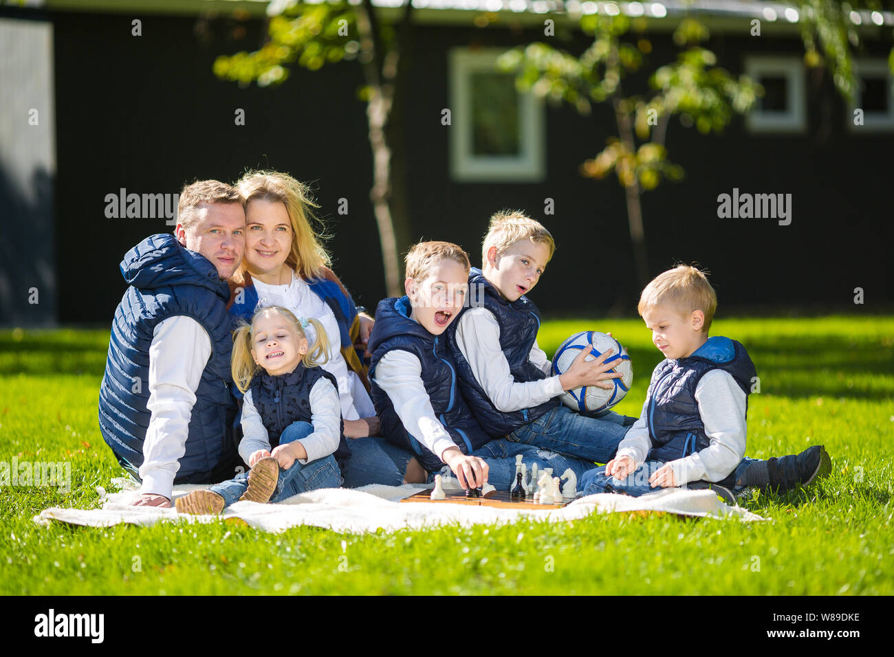 Big Family Relaxing In Green Nature. Happy family portrait on outdoor ...