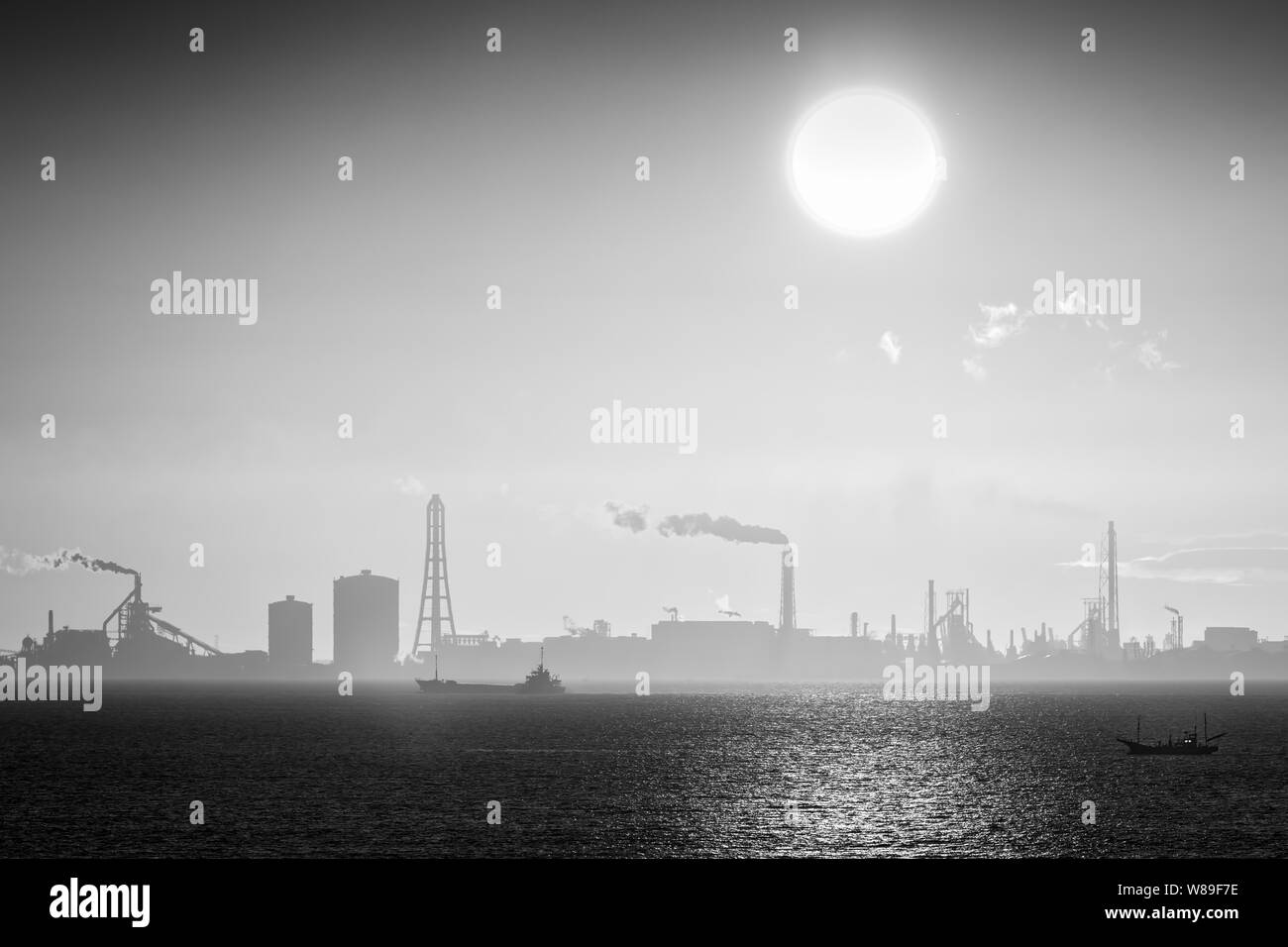 A ship and a trawler passing through Tokyo Bay at sunrise in Japan. Stock Photo