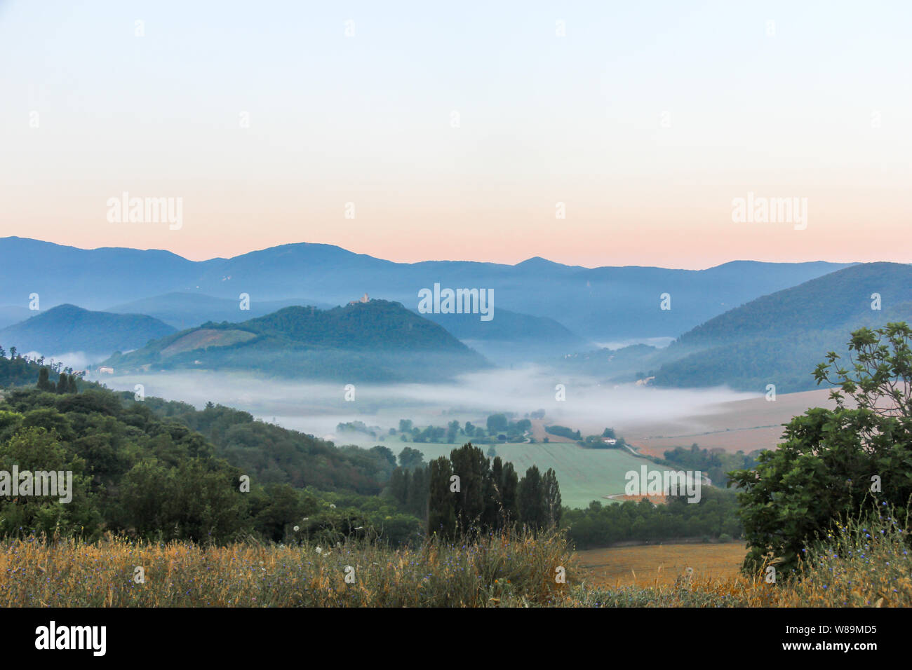 Mist lying in a valley, dawn, Umbria, Italy Stock Photo