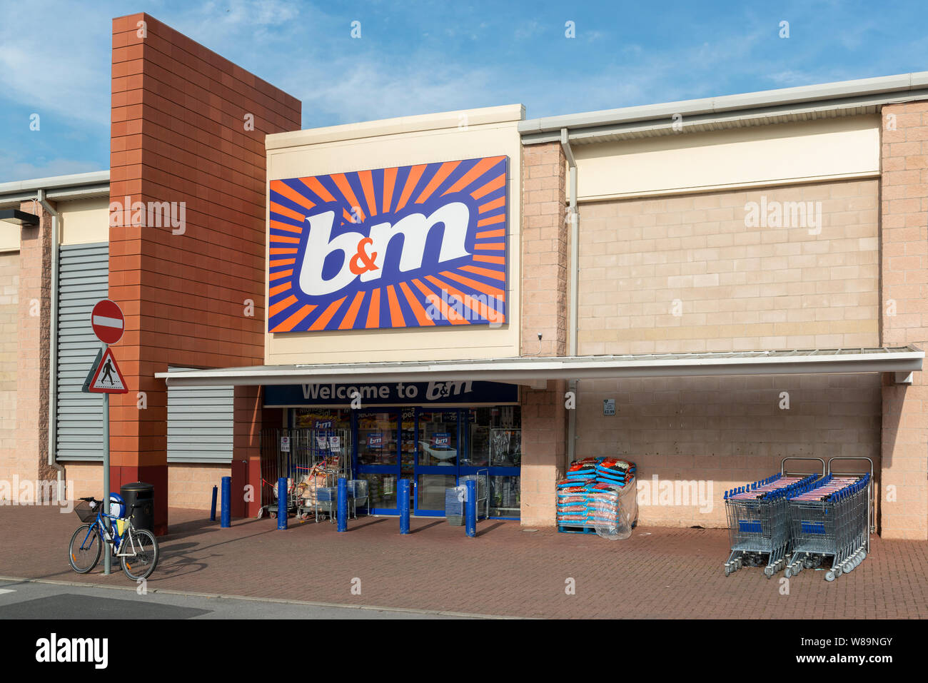 The storefront of the retailer B&M on a retail park in Baguley, Manchester. (Editorial use only). Stock Photo