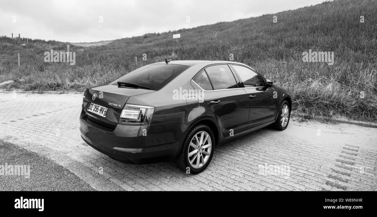 Overveen, Netherlands - Aug 16, 2018: Rear view of new Skoda Octavia Parked on a beach park space in Netherlands on a cloudy day black and white image Stock Photo