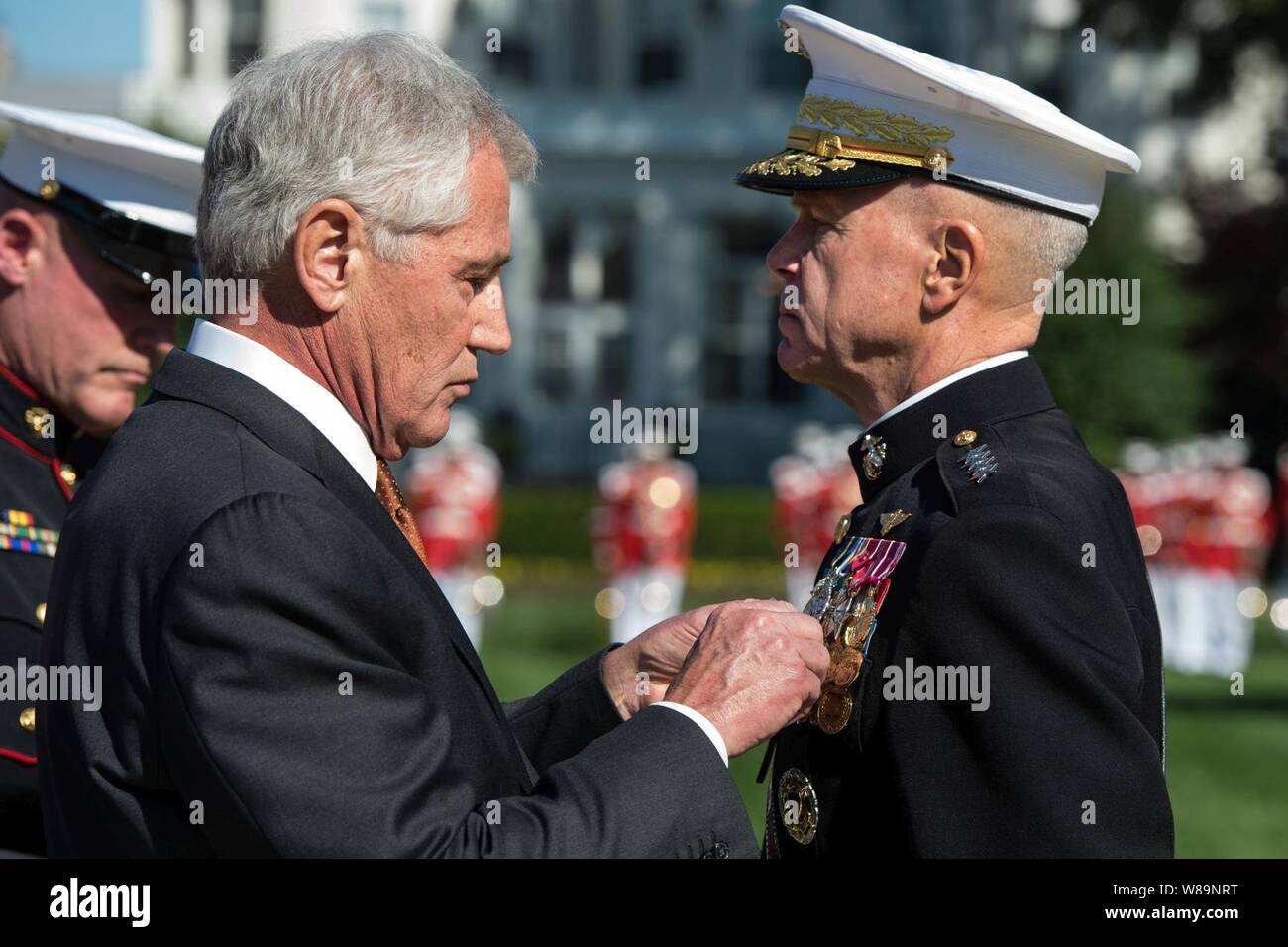 Defense Secretary Chuck Hagel pins a medal on outgoing Marine Corps Commandant Gen. James F. Amos during a change-of-command ceremony on Marine Barracks in Washington, D.C 141017-N-AF077-131c. Stock Photo