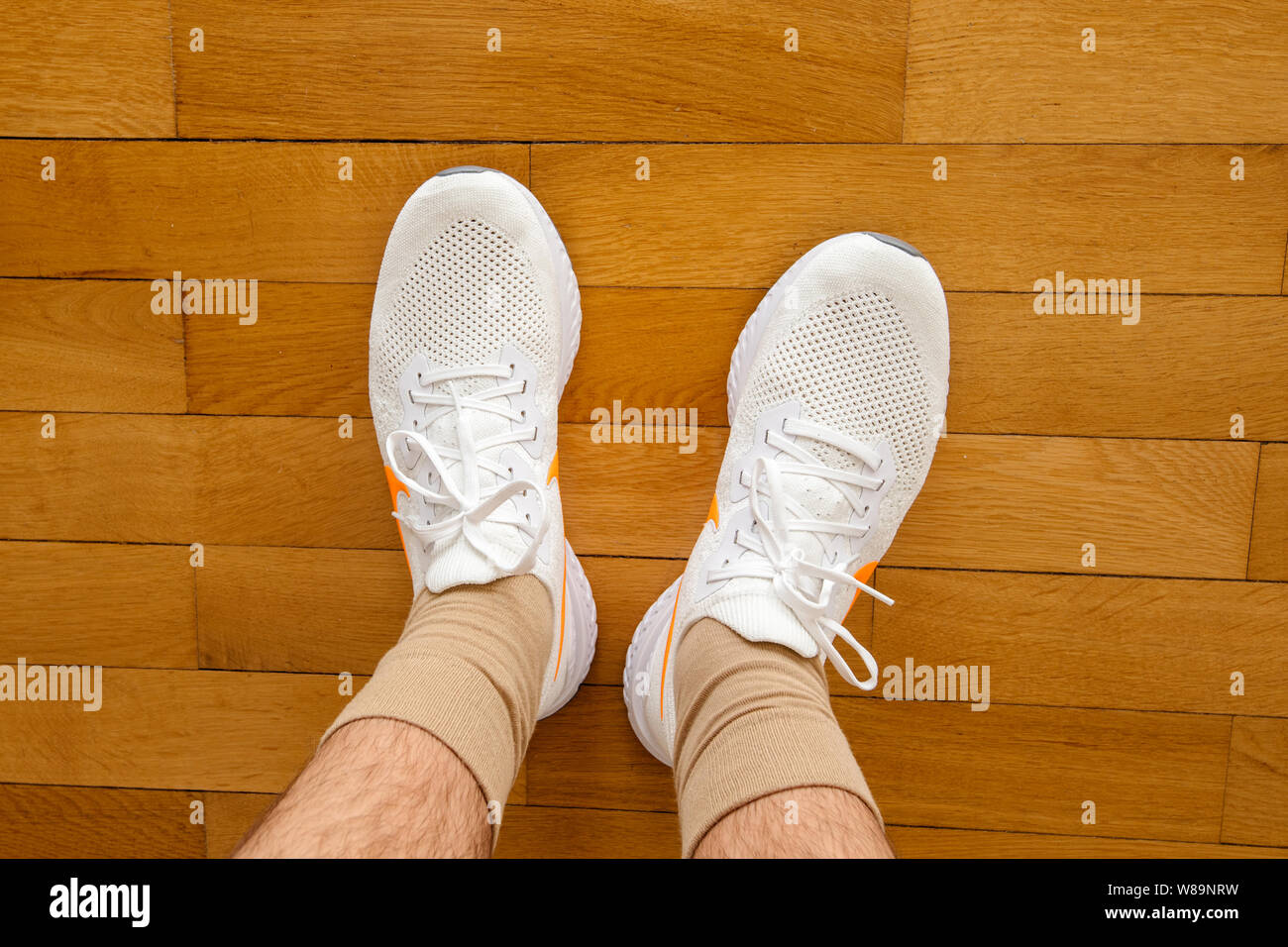 Paris France - Jul 13 2019: Man wearing measuring new Nike Epic React  Flyknit 2 running shoes equipment on the living room wooden floor  manufactured by Nike sportswear Stock Photo - Alamy