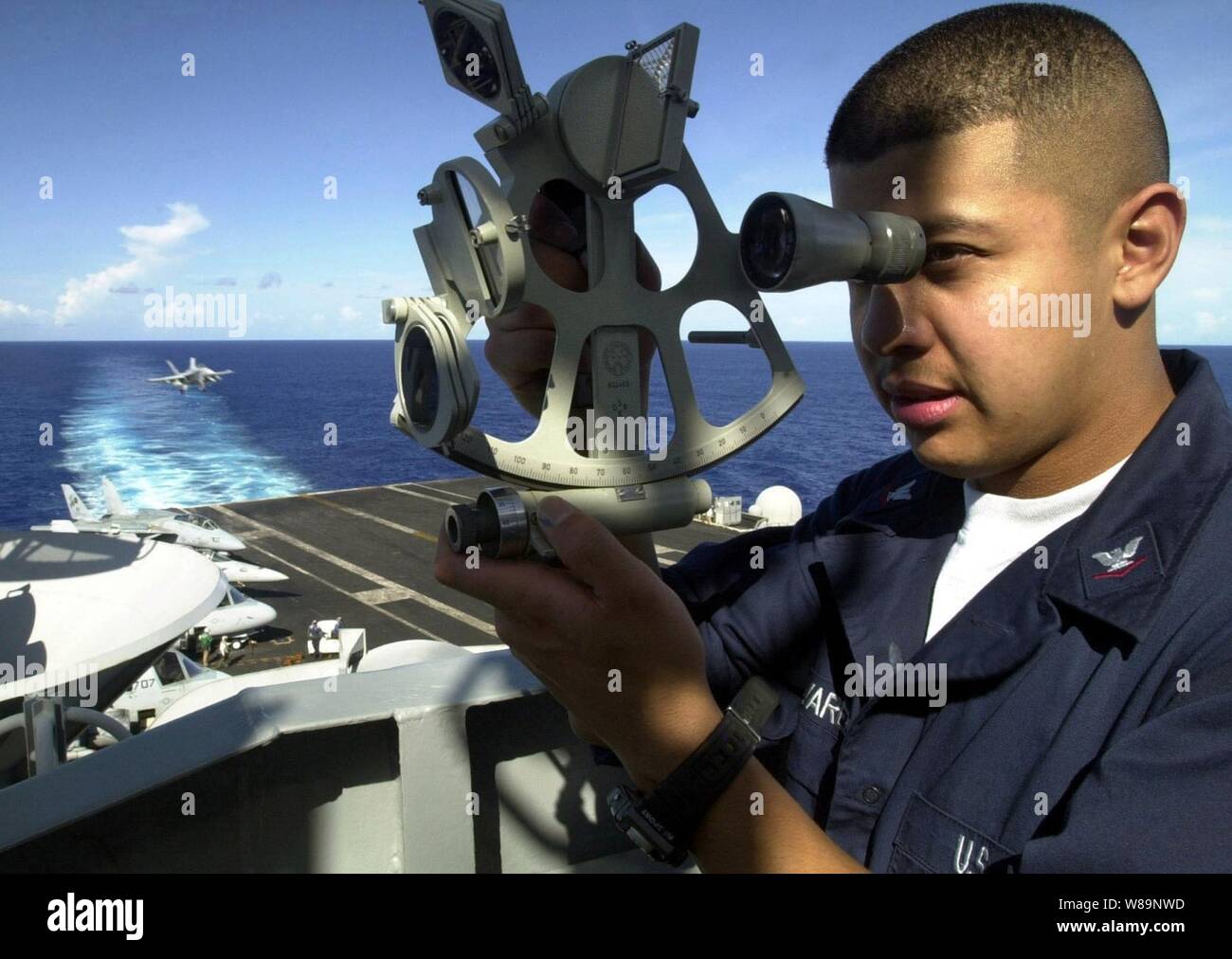 Petty Officer 3rd Class Michael Alvarez uses a sextant to plot the navigational position of the USS Abraham Lincoln (CVN 72) at sea on Sept. 3, 2000.  Alvarez, from Los Angeles, Calif., is a Navy quartermaster onboard the aircraft carrier.  The Lincoln, its embarked Carrier Air Wing 14 and the Lincoln Battle Group are en route to the Persian Gulf on a routine six-month deployment. Stock Photo