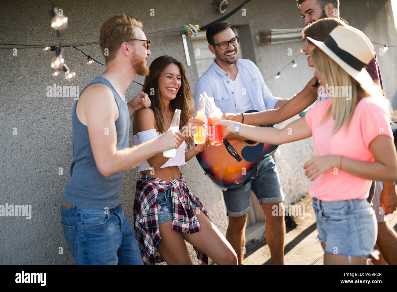 Group of young people having fun at a summertime party, at sunset Stock ...