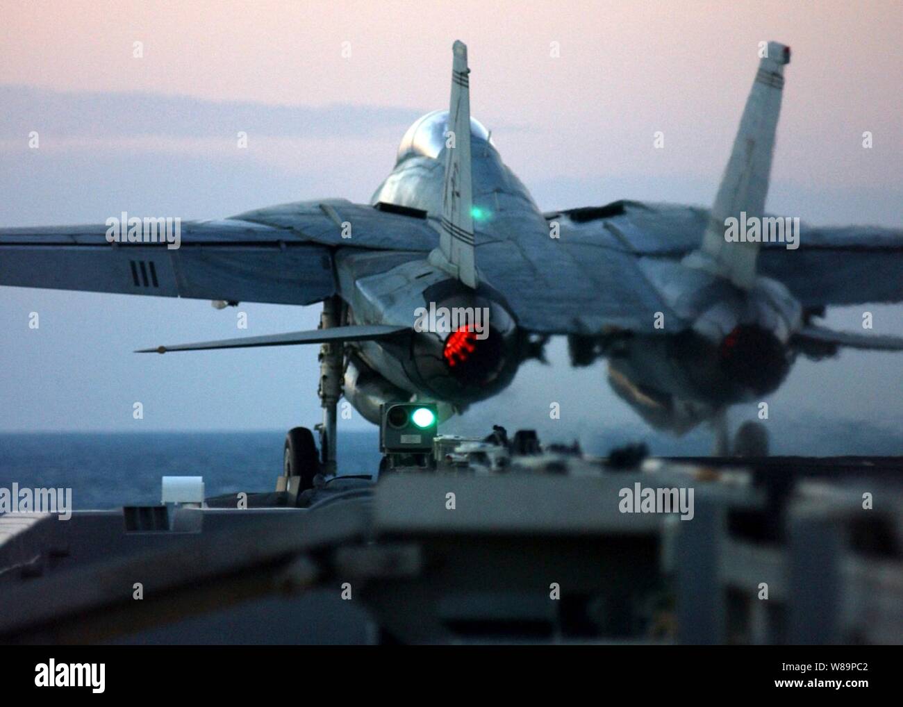 An F-14B Tomcat is catapulted from the flight deck of the aircraft carrier USS Harry S. Truman (CVN 75) during evening flight operations in the Persian Gulf on Dec. 4, 2004.  Truman and its embarked Carrier Air Wing 3 are providing close air support and conducting intelligence, surveillance, and reconnaissance missions over Iraq.  The Tomcat is assigned to Fighter Squadron 32. Stock Photo