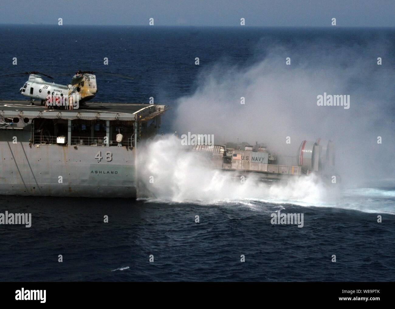 A Navy Landing Craft Air Cushion blows up a curtain of spray as it maneuvers to enter the well deck of the amphibious dock landing ship USS Ashland (LSD 48) during training exercises in the Mediterranean Sea on April 20, 2005.  The Landing Craft Air Cushion, more commonly known as an LCAC, is assigned to Assault Craft Unit 4 deployed onboard the Ashland. Stock Photo