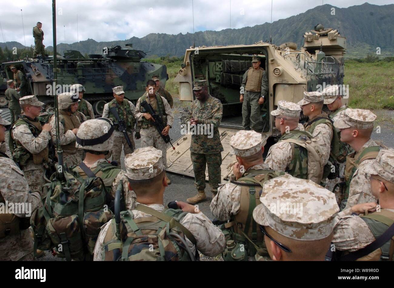Marine Capt. Benjamin Venning (center) talks to his Marines after they finished training with their amphibious assault vehicles in Kauai, Hawaii, on June 27, 2005.  The Marines from the 3rd Amphibious Assault Battalion are conducting amphibious training on the beaches of the Pacific Missile Range Facility on Kauai. Venning is the 3rd Amphibious Assault Battalion company commander. Stock Photo