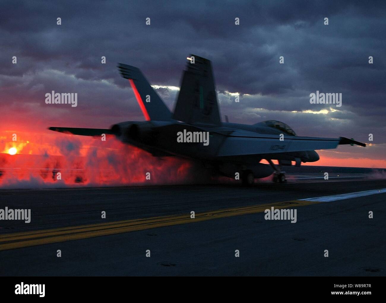 An F/A-18F Super Hornet is catapulted off of the fight deck of the aircraft carrier USS Dwight D. Eisenhower (CVN 69) during sunset flight operations on Oct. 29, 2005. The Nimitz-class aircraft carrier is underway conducting flight deck certification after completing a four-month post shakedown availability. Stock Photo