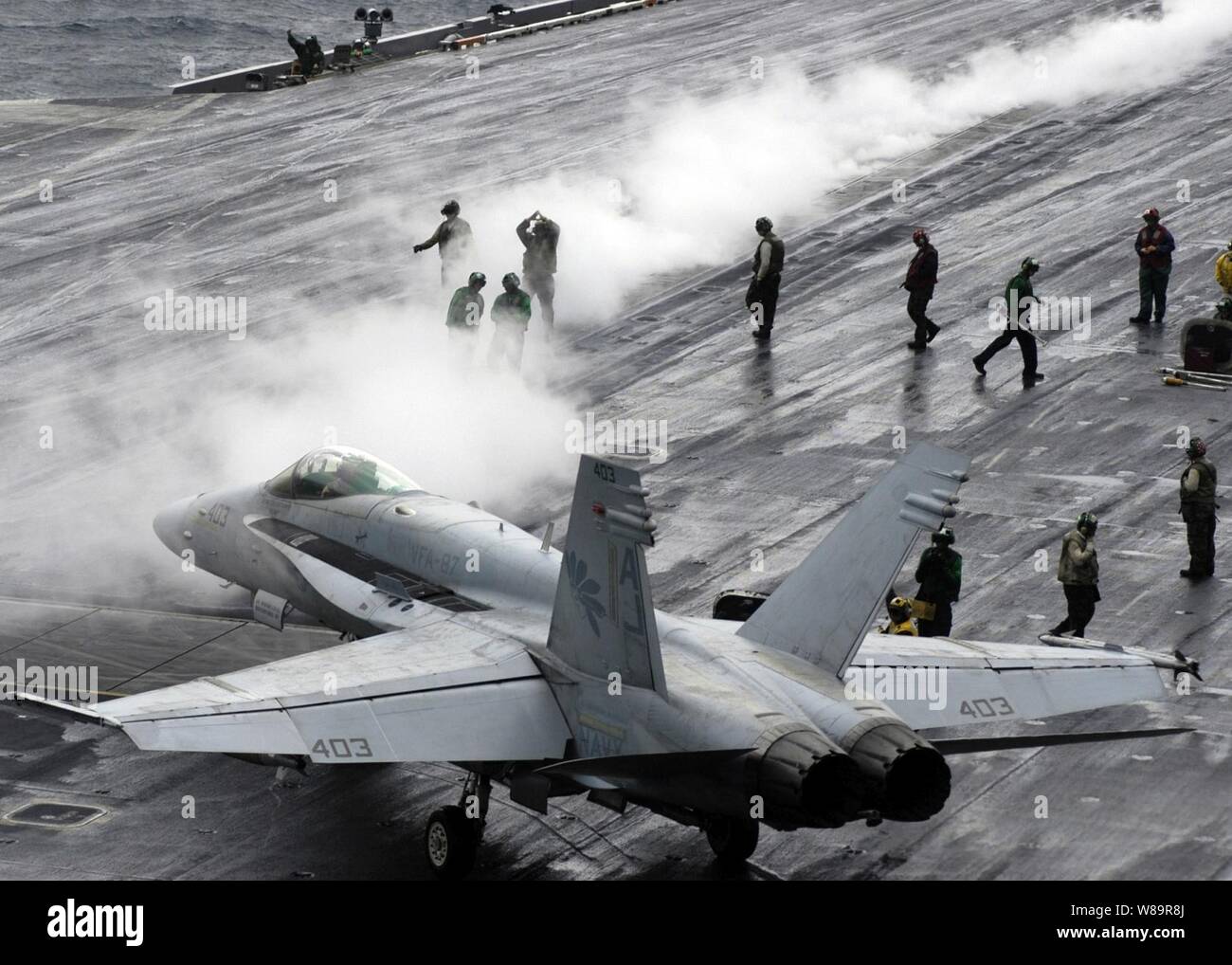 A Navy F/A-18C Hornet taxies to a steam-powered catapult on the flight deck of the aircraft carrier USS Theodore Roosevelt (CVN 71) as the ship conducts flight operations in the Persian Gulf on Nov. 16, 2005.  The aircraft of Carrier Air Wing 8 are flying missions from the Roosevelt to support Operation Steel Curtain.  The Hornet is attached to Strike Fighter Squadron 87 of Naval Air Station Oceana, Va. Stock Photo
