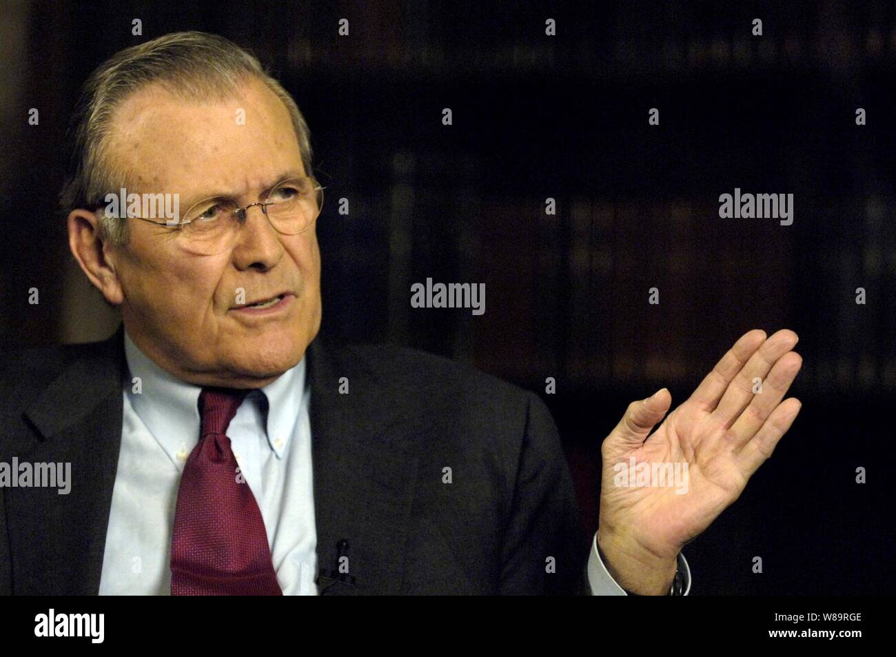 Secretary of Defense Donald H. Rumsfeld responds to a reporter's question during a television interview in Munich, Germany, on Feb. 3, 2006.  Rumsfeld is in Munich to attend the 42nd Munich Conference on Security Policy.   Over 40 foreign and defense ministers from around the world are attending the three-day conference to discuss global security issues. Stock Photo
