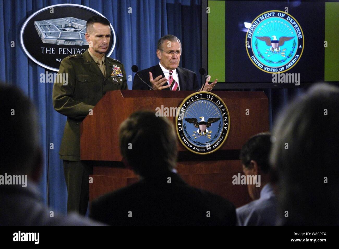 Secretary of Defense Donald H. Rumsfeld gestures to make a point as he answers a reporter's question during a Pentagon press briefing with Chairman of the Joint Chiefs of Staff Gen. Peter Pace, U.S. Marine Corps, in Arlington, Va., on March 28, 2006. Rumsfeld spoke of his trip to the crash site of United Flight 93 on Sept. 11, 2001, in Shanksville, Pa., in his opening remarks before he and Pace took questions from reporters. Stock Photo