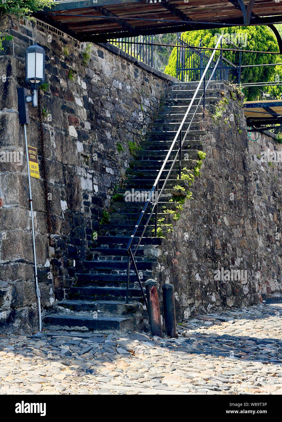 A stone stairway leading up to a higher level from a stone roadway near the Savannah riverfront. Stock Photo