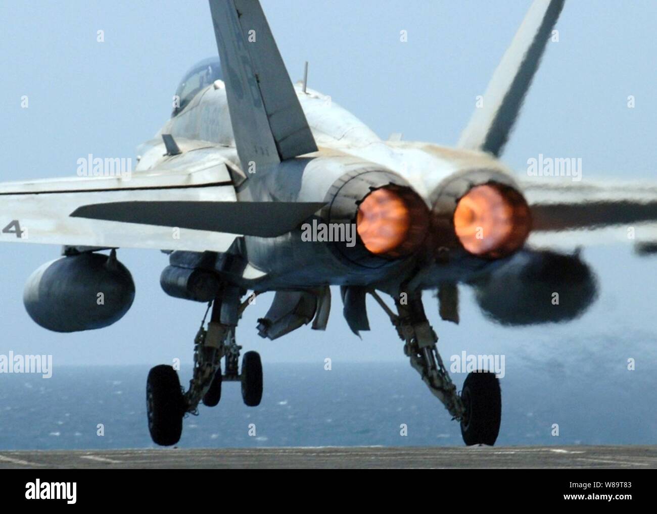 Afterburners glow as an F/A-18C Hornet aircraft launches from the flight deck of the aircraft carrier USS Enterprise (CVN 65) while the ship conducts flight operations in the Persian Gulf on June 10, 2006.  Enterprise and its embarked Carrier Air Wing 1 are conducting maritime security operations in the area. Stock Photo