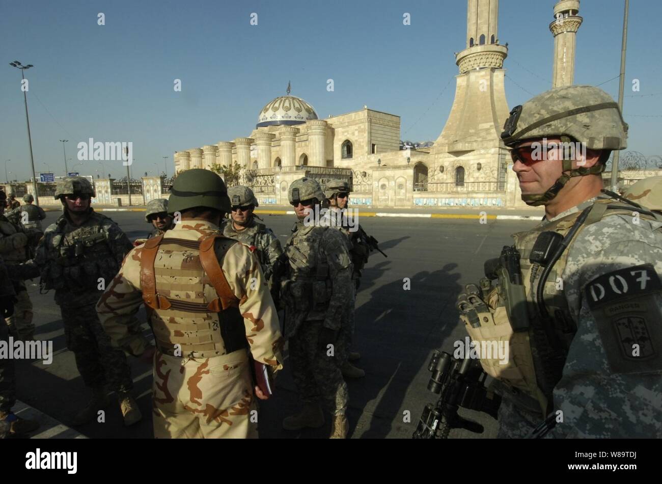U.S. Army 1st Sgt. Dan L. Schoemaker helps secure the street outside of a mosque in the Ad Hamyah district of Baghdad, Iraq, so Iraqi army soldiers from the 9th Iraqi army can search it for ammunition caches on Sept. 2, 2006.  Schoemaker is assigned to Charlie Company, 1st Battalion, 17th Infantry Regiment, 172nd Stryker Brigade Combat Team. Stock Photo