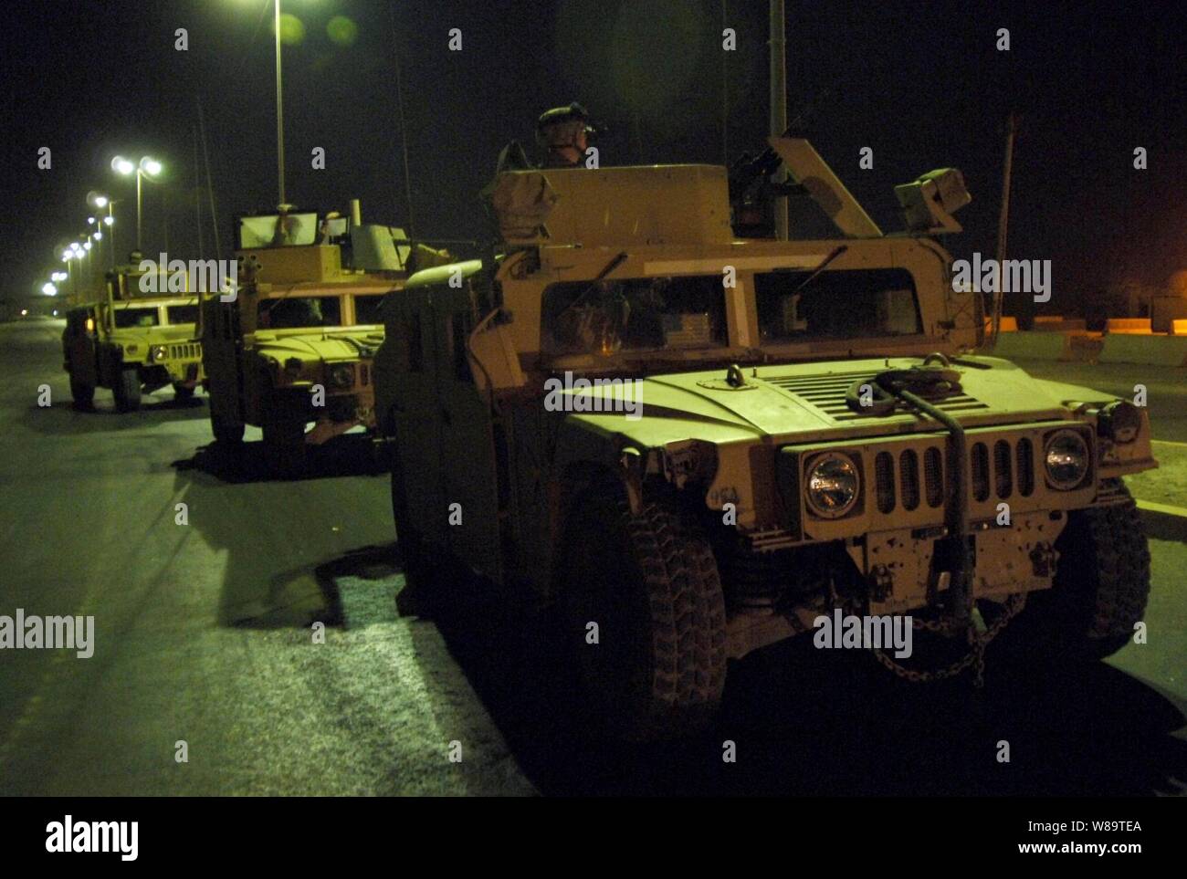 U.S. Army soldiers with the 4th Battalion, 320th Field Artillery, 506th Regimental Combat Team, 101st Airborne Division conduct a night patrol in the Zafaraniya District of East Baghdad, Iraq, on Aug. 13, 2006. Stock Photo