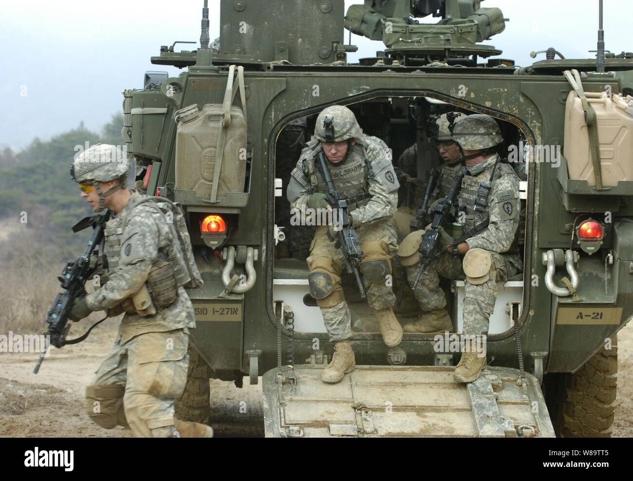 U.S. Army soldiers from Alpha Company, 1st Battalion, 27th Infantry Regiment, 2nd Stryker Brigade Combat Team exit their M1126 Stryker Infantry Carrier Vehicle during dismounted maneuvers at Warrior Valley on Rodriguez Range Complex, South Korea, on March 24, 2007, as part of exercise Foal Eagle 2007.  The annual joint command post and field training exercise improves combat readiness and joint and combined interoperability. Stock Photo