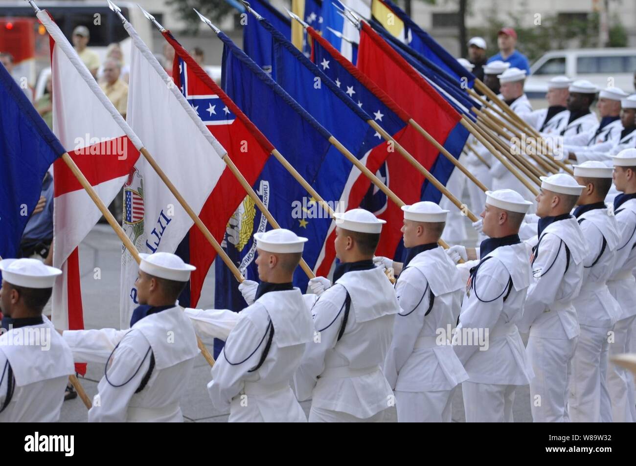 The Navy Ceremonial Honor Guard renders honors during the National Anthem for the commencement of the Navy District Washington's Concert on the Avenue in Washington, D.C., on July 31, 2007.  The Navy Band performs on the Memorial Plaza every Tuesday night between Memorial Day and Labor Day. Stock Photo