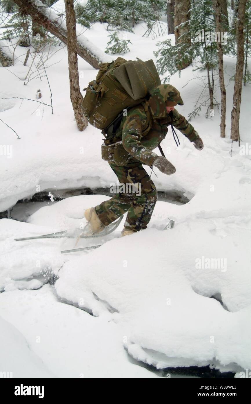 A student at the Navy's Survival, Evasion, Resistance and Escape school snowshoes across a frozen creek during training in Rangely, Maine, on Feb. 3, 2008. Stock Photo