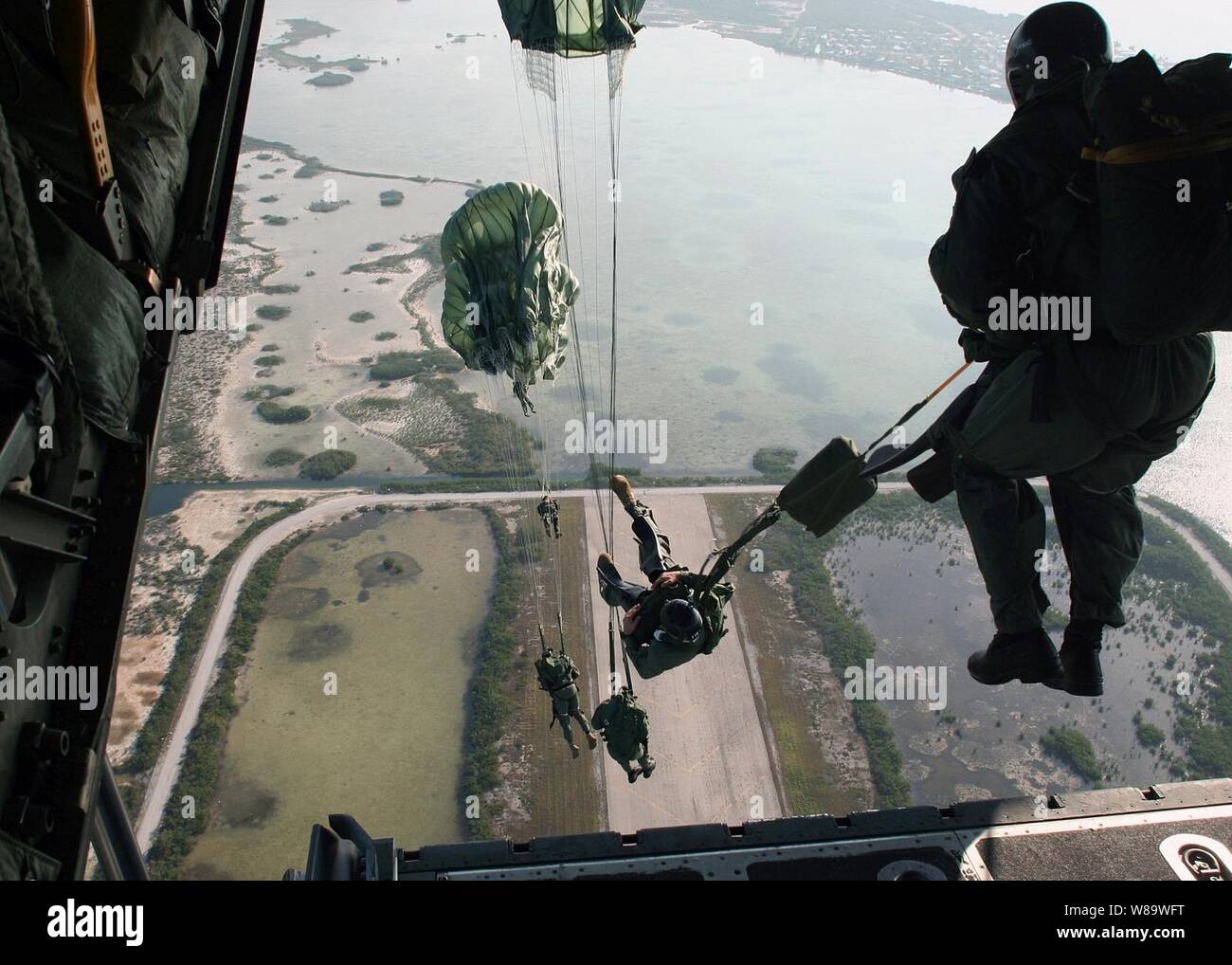 U.S. Navy Special Warfare Combatant-craft Crewmen assigned to Special Boat Team 20 jump from an Air Force C-130 Hercules aircraft during a static-line parachute jump over Key West Fla., on March 3, 2008. Stock Photo