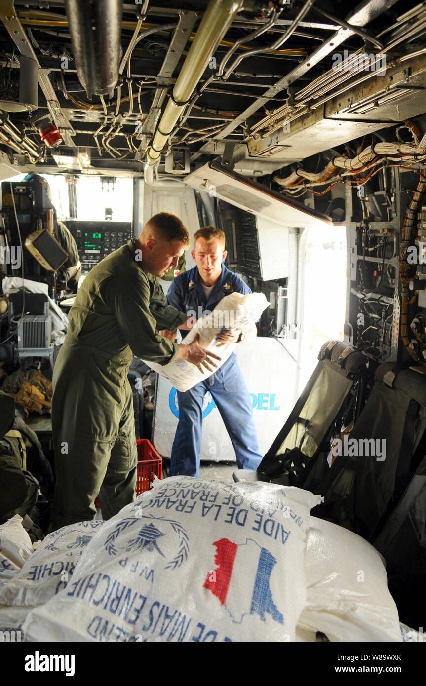 U.S. military personnel embarked aboard the amphibious assault ship USS Kearsarge (LHD 3) load supplies onto a helicopter in Port-au-Prince, Haiti, on Sept. 9, 2008.  The island has been hit by three tropical storms and Hurricane Ike.  The Kearsarge was diverted from its deployment in support of the humanitarian assistance mission Continuing Promise 2008 to conduct hurricane relief operations in Haiti. Stock Photo