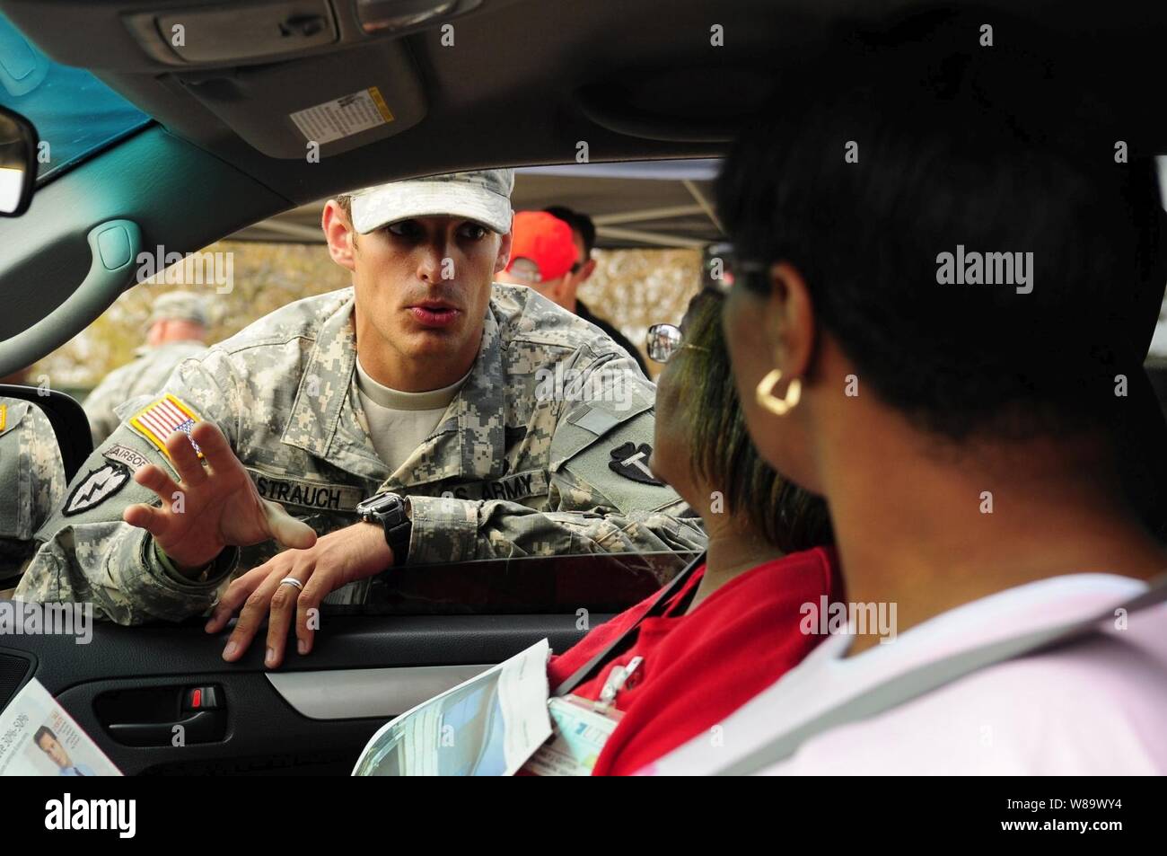 U.S. Army Spc. Peter Strauch, of the Texas Army National Guard, explains Federal Emergency Management Agency relief efforts to citizens at a point of distribution site in Galveston, Texas, on Sept. 19, 2008.  The U.S. Army is contributing to the Hurricane Ike humanitarian assistance operations being led by the Federal Emergency Management Agency in conjunction with the Department of Defense. Stock Photo