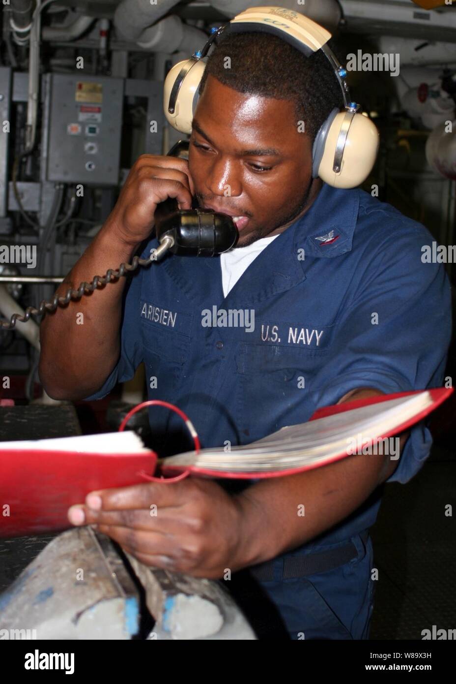 U.S. Navy Petty Officer 3rd Class Paris Pharisien gives a status report during a roving watch aboard the amphibious transport dock ship USS San Antonio (LPD 17) underway in the Persian Gulf on Dec. 2, 2008.  The San Antonio is deployed with the Iwo Jima Expeditionary Strike Group to support maritime security operations in the U.S. 5th Fleet area of responsibility. Stock Photo