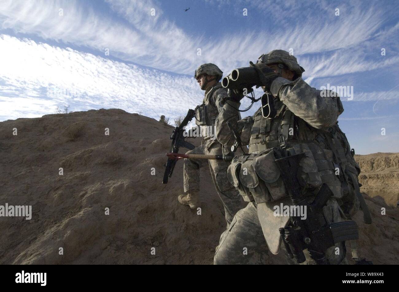 U.S. Army soldiers of 3rd Battalion, 21st Infantry Regiment, 1st Stryker Brigade Combat Team, 25th Infantry Division scan for suspicious activity during a patrol of the Diyala River Valley in Iraq on Dec. 27, 2008. Stock Photo