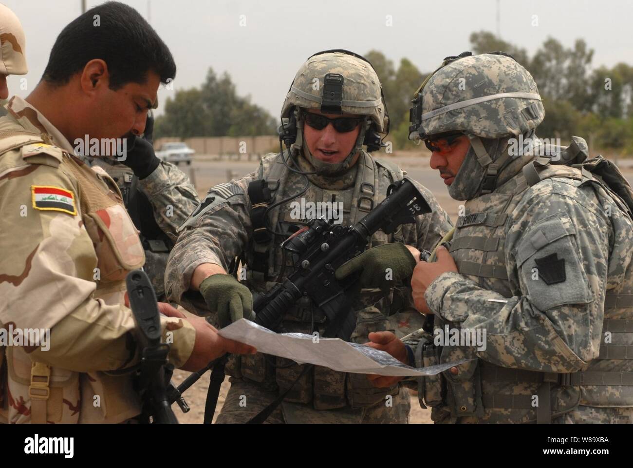 U.S. Army 1st Lt. Andrew Dacey from the 2nd Brigade, 1st Infantry Division reviews security checkpoints with Iraqi soldiers in the city of Abu Ghraib, Iraq, on March 31, 2009. Stock Photo