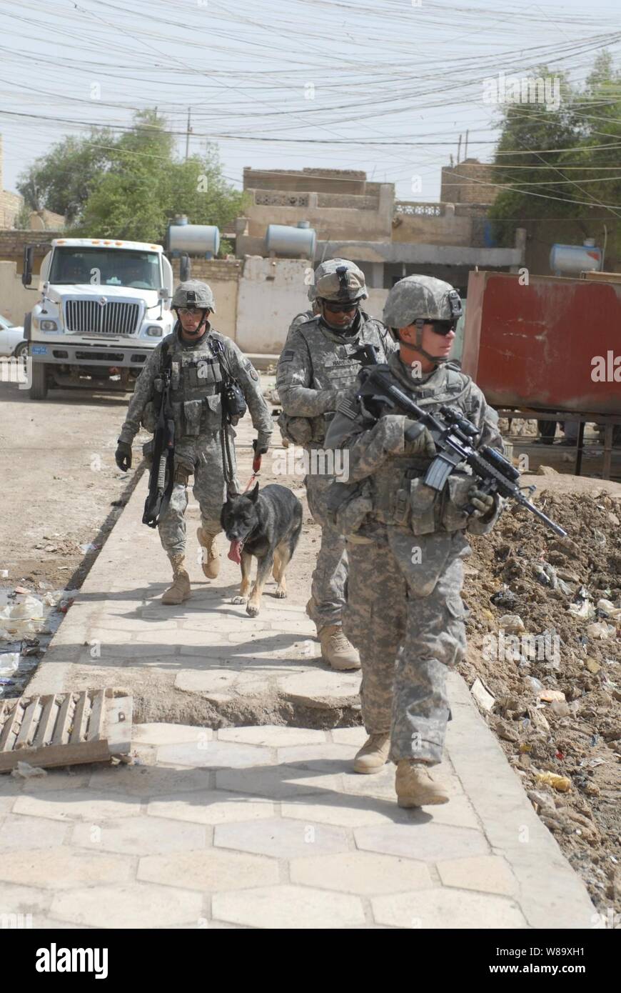 U.S. Army soldiers attached to 4th Battalion, 6th Infantry Regiment, 4th Brigade Combat Team, 1st Armored Division and soldiers attached to the provost marshalís office with Multi-National Corps - Iraq search for evidence of insurgency in a town in the Maysan province of Iraq on June 2, 2009. Stock Photo