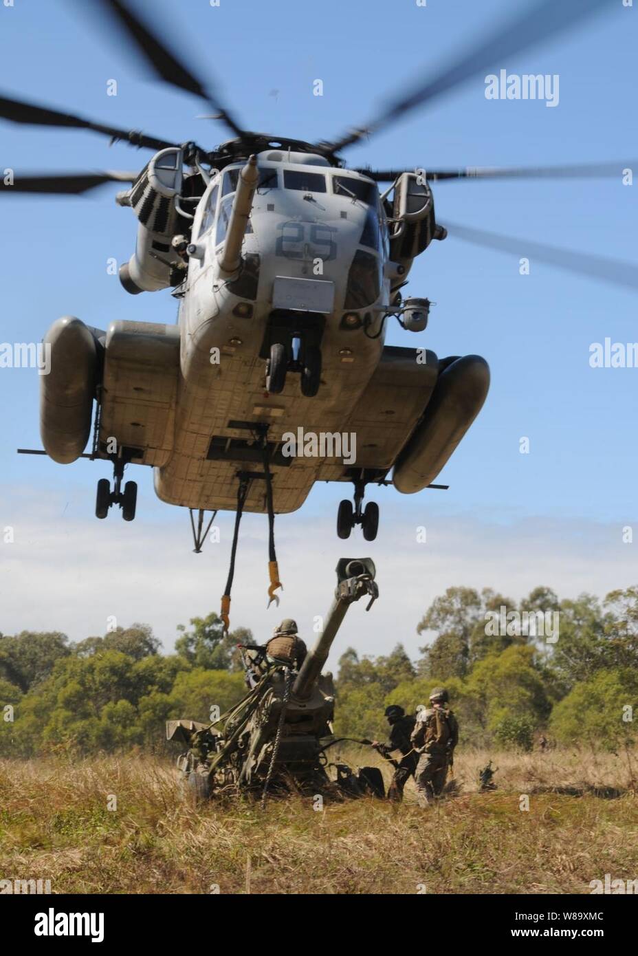 A U.S. Marine Corps MH-53E Sea Stallion helicopter, assigned to the Air Combat Element of the 31st Marine Expeditionary Unit, embarked aboard the forward-deployed amphibious assault ship USS Essex (LHD 2), prepares to lift an M777 155mm lightweight howitzer in Shoalwater Bay, Australia, as part of Talisman Sabre 2009 on July 19, 2009.  Talisman Sabre is a combined training exercise designed to train Australian and U.S. forces in planning and conducting combined operations, which will help improve combat readiness and interoperability. Stock Photo