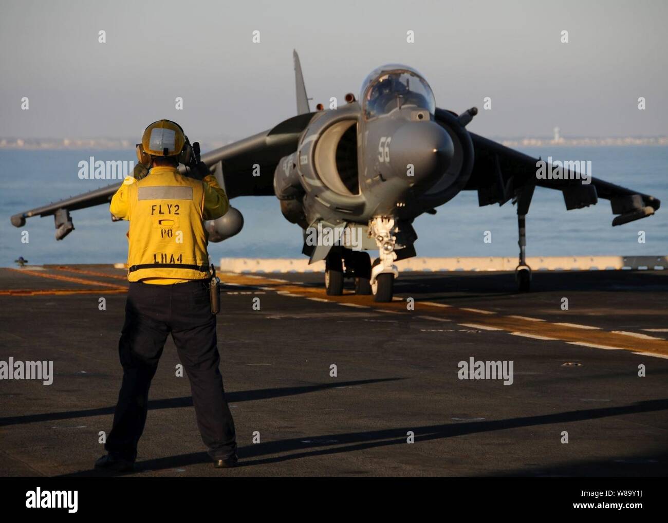 An AV-8B Harrier II vertical short takeoff and landing jet powers up its engines before taking off from the flight deck of the amphibious assault ship USS Nassau (LHA 4) in the Atlantic Ocean on Dec. 14, 2009.  The Nassau is underway with other elements of the Nassau Amphibious Ready Group and the embarked 24th Marine Expeditionary Unit for a certification exercise. Stock Photo