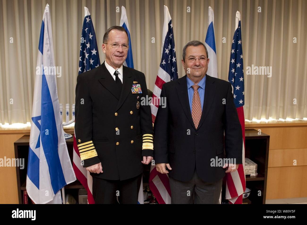 Chairman of the Joint Chiefs of Staff Adm. Mike Mullen, U.S. Navy, poses for photos with Israeli Minister of Defense Ehud Barak in Tel Aviv, Israel, on Feb. 15, 2010.  Mullen is on a weeklong tour of the region visiting with key partners and allies. Stock Photo