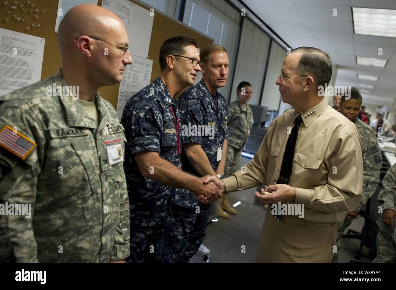 Chairman of the Joint Chiefs of Staff Adm. Mike Mullen, U.S. Navy, greets sailors assigned to the Deepwater Horizon Unified Command Center in New Orleans, La., on August 2, 2010.  Mullen and his wife Deborah visited the command and control center to receive an operational update and to thank the service members and civilians working to help contain the largest oil spill in U.S. history. Stock Photo