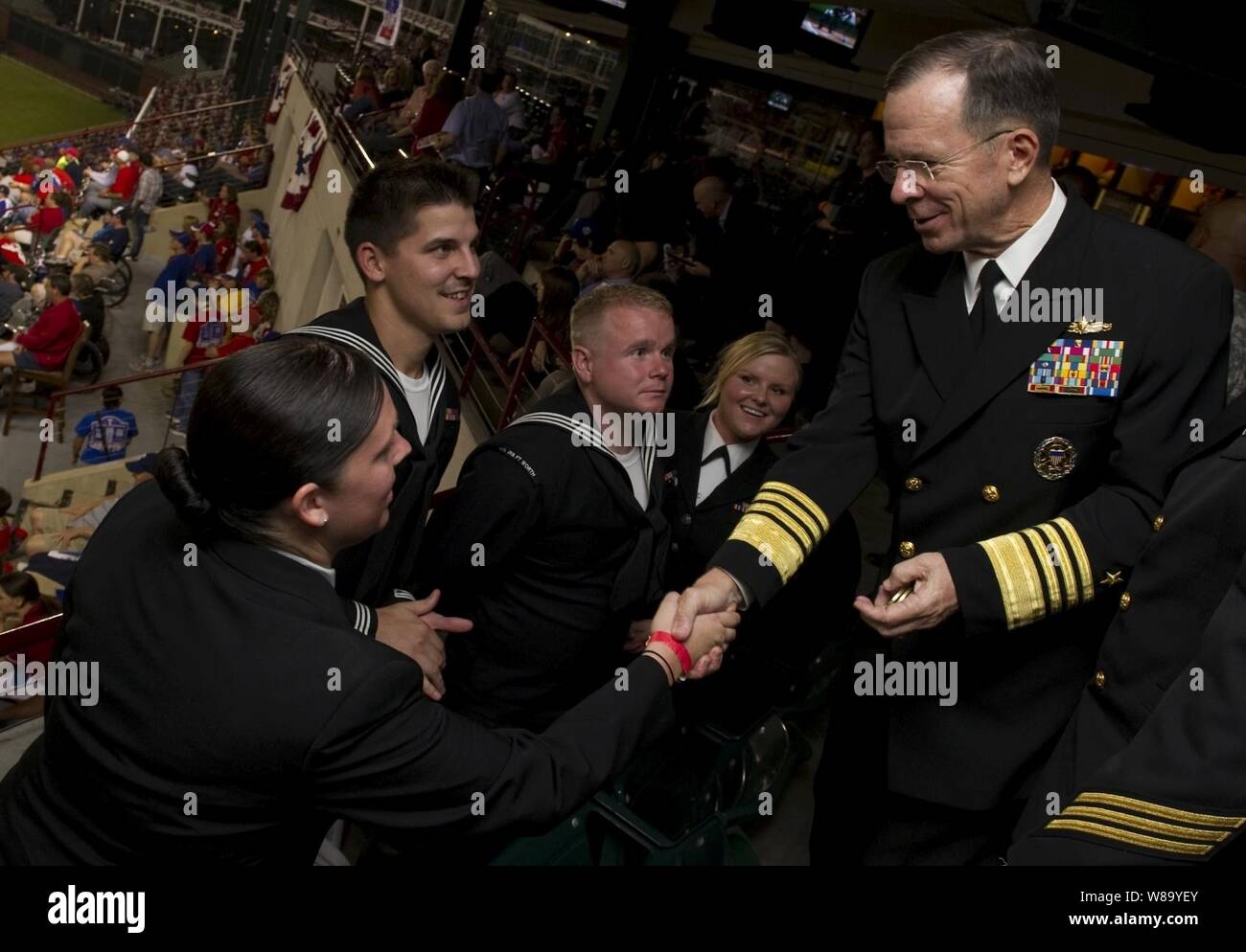 Chairman of the Joint Chiefs of Staff Adm. Mike Mullen greets Navy sailors at Game 4 of the 106th World Series between the San Francisco Giants and Texas Rangers in Arlington, Texas, on Oct. 31, 2010.  Major League Baseball dedicated the game to the Welcome Back Veterans initiative that honors and encourages support of returning military members and their families. Stock Photo